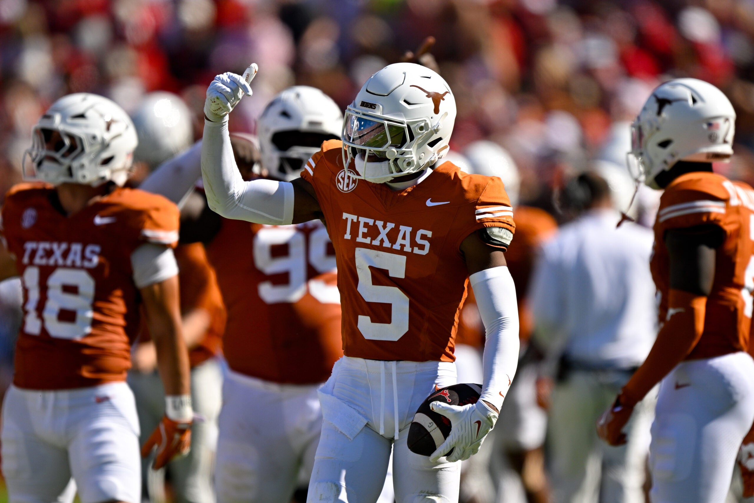 Oct 11, 2025; Dallas, Texas, USA; Texas Longhorns defensive back Malik Muhammad (5) celebrates after he intercepts a pass thrown by Oklahoma Sooners quarterback John Mateer (not pictured) during the first half at the Cotton Bowl.