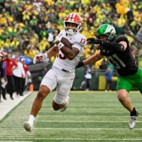 Oct 11, 2025; Eugene, Oregon, USA; Indiana Hoosiers wide receiver Elijah Sarratt (13) runs with the ball after making a catch against Oregon Ducks defensive back Dillon Thieneman (31) during the fourth quarter at Autzen Stadium.