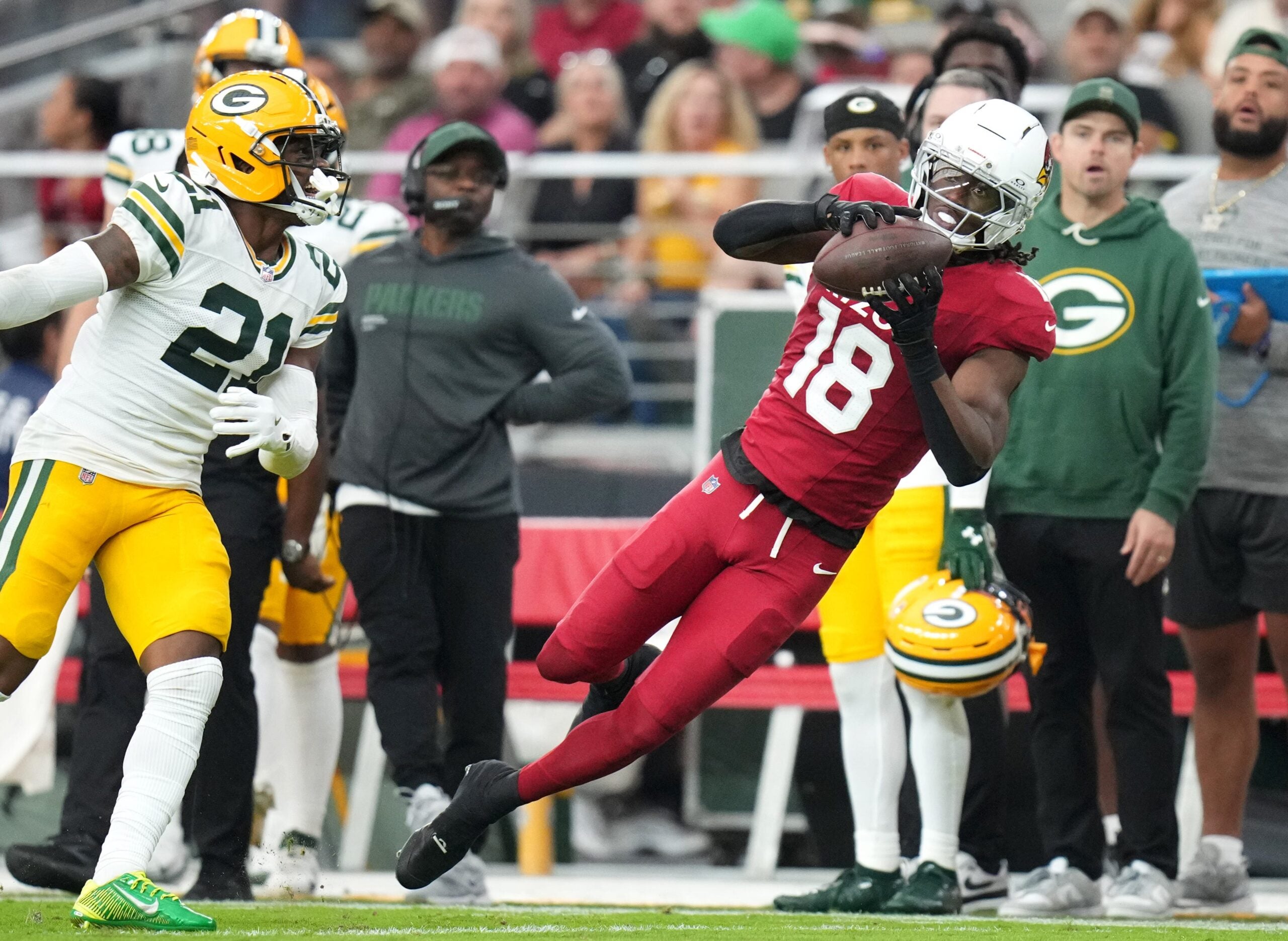 Arizona Cardinals receiver Marvin Harrison Jr. (18) catches a pass along the sidelines against the Green Bay Packers at State Farm Stadium in Glendale on Oct. 19, 2025.