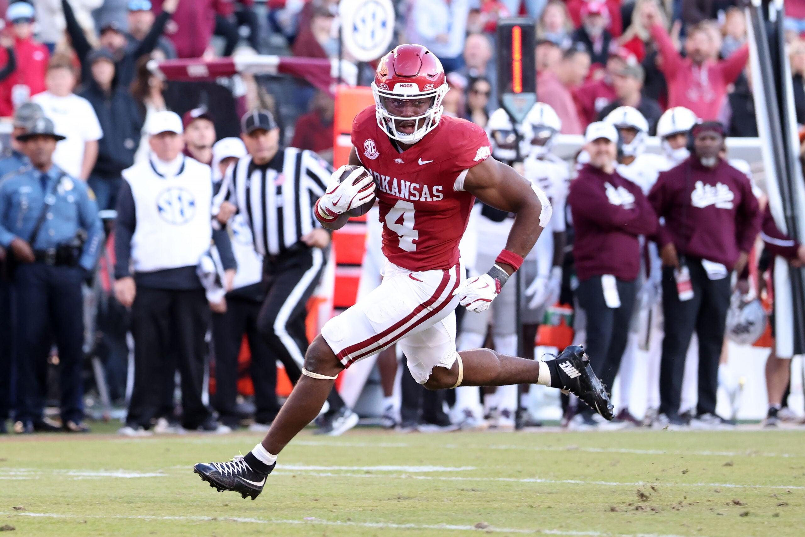 Nov 1, 2025; Fayetteville, Arkansas, USA; Arkansas Razorbacks running back Mike Washington Jr (4) rushes for a touchdown during the third quarter against the Mississippi State Bulldogs at Donald W. Reynolds Razorback Stadium. Bulldogs won 38-35.