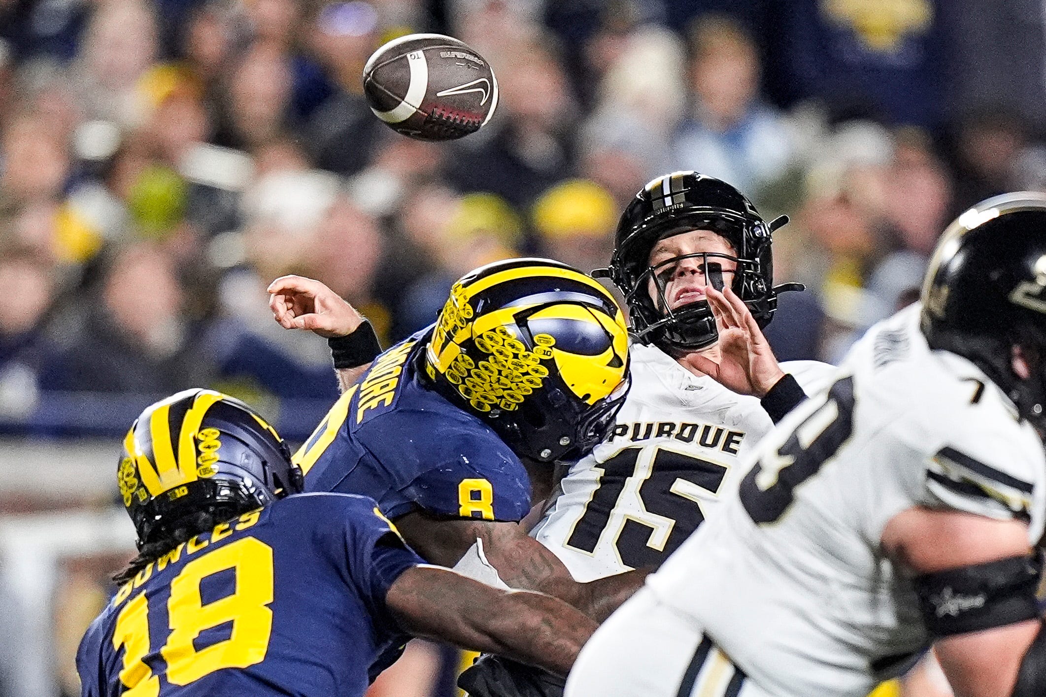 Michigan defensive end Derrick Moore (8) forces Purdue quarterback Ryan Browne (15) to fumble during the first half at Michigan Stadium in Ann Arbor on Saturday, November 1, 2025.