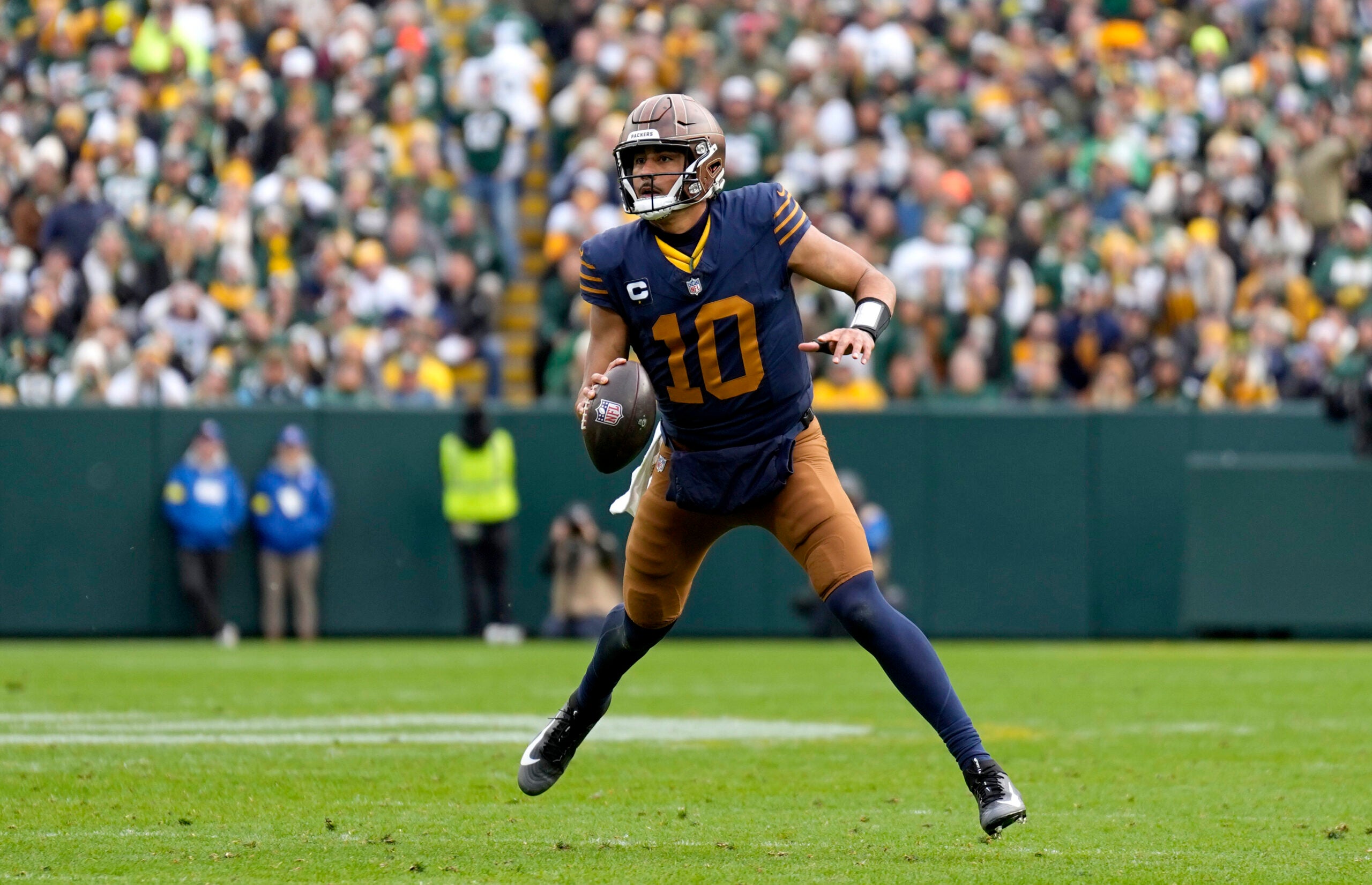 Nov 2, 2025; Green Bay, Wisconsin, USA; Green Bay Packers quarterback Jordan Love (10) scrambles during the second half against the Carolina Panthers at Lambeau Field.