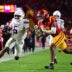 Nov 7, 2025; Los Angeles, California, USA; Northwestern Wildcats running back Caleb Komolafe (5) runs the ball against Southern California Trojans safety Kamari Ramsey (7) during the first half at the Los Angeles Memorial Coliseum.
