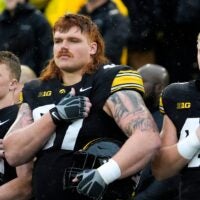Iowa Hawkeyes offensive lineman Gennings Dunker (67), center, stands with teammates for the national anthem Nov. 8, 2025 before a Big Ten Football game against the Oregon Ducks at Kinnick Stadium in Iowa City, Iowa.