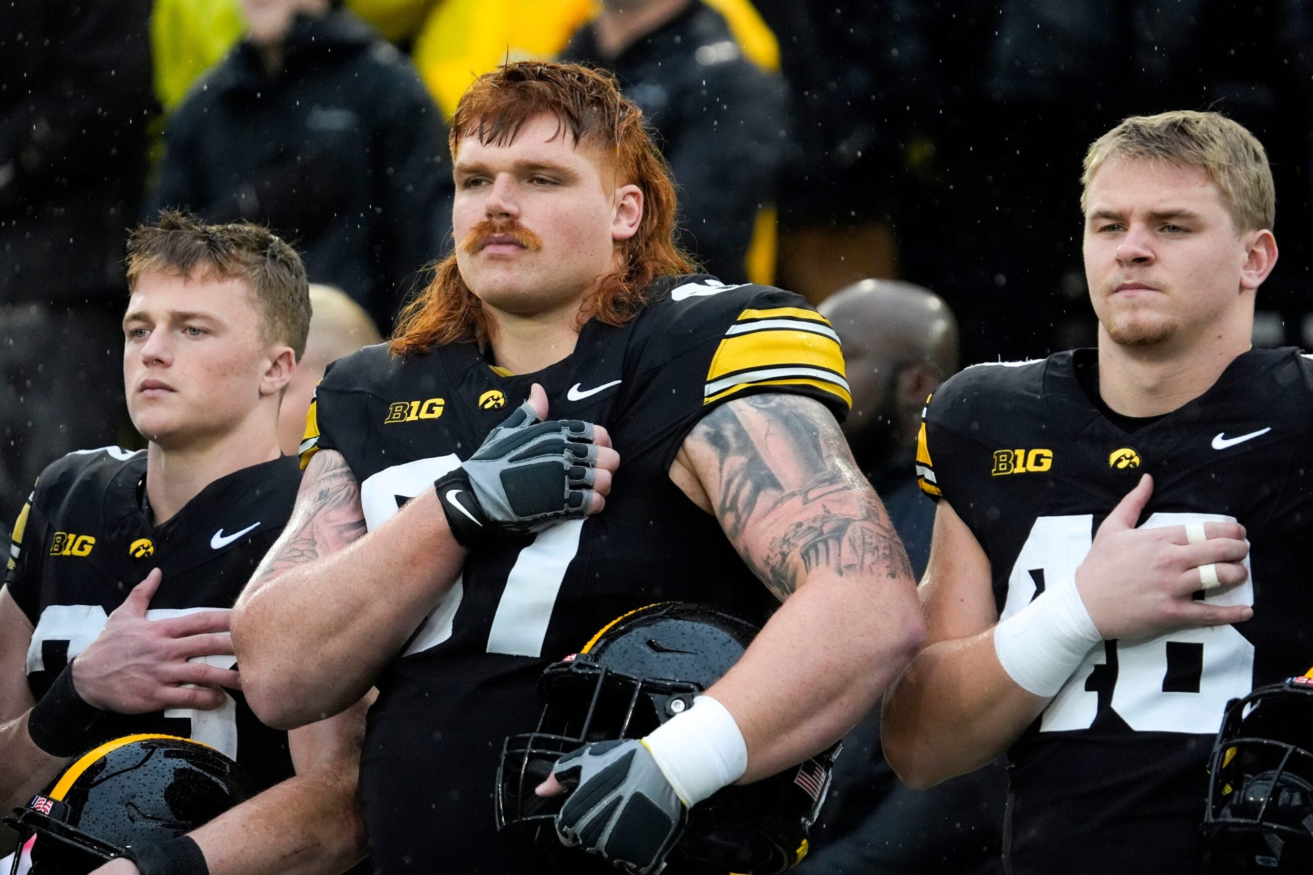 Iowa Hawkeyes offensive lineman Gennings Dunker (67), center, stands with teammates for the national anthem Nov. 8, 2025 before a Big Ten Football game against the Oregon Ducks at Kinnick Stadium in Iowa City, Iowa.
