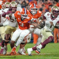 Nov 8, 2025; Clemson, South Carolina, USA; Florida State Seminoles quarterback Tommy Castellanos (1) runs near Clemson Tigers defensive end T.J. Parker (3) during the second quarter at Memorial Stadium.