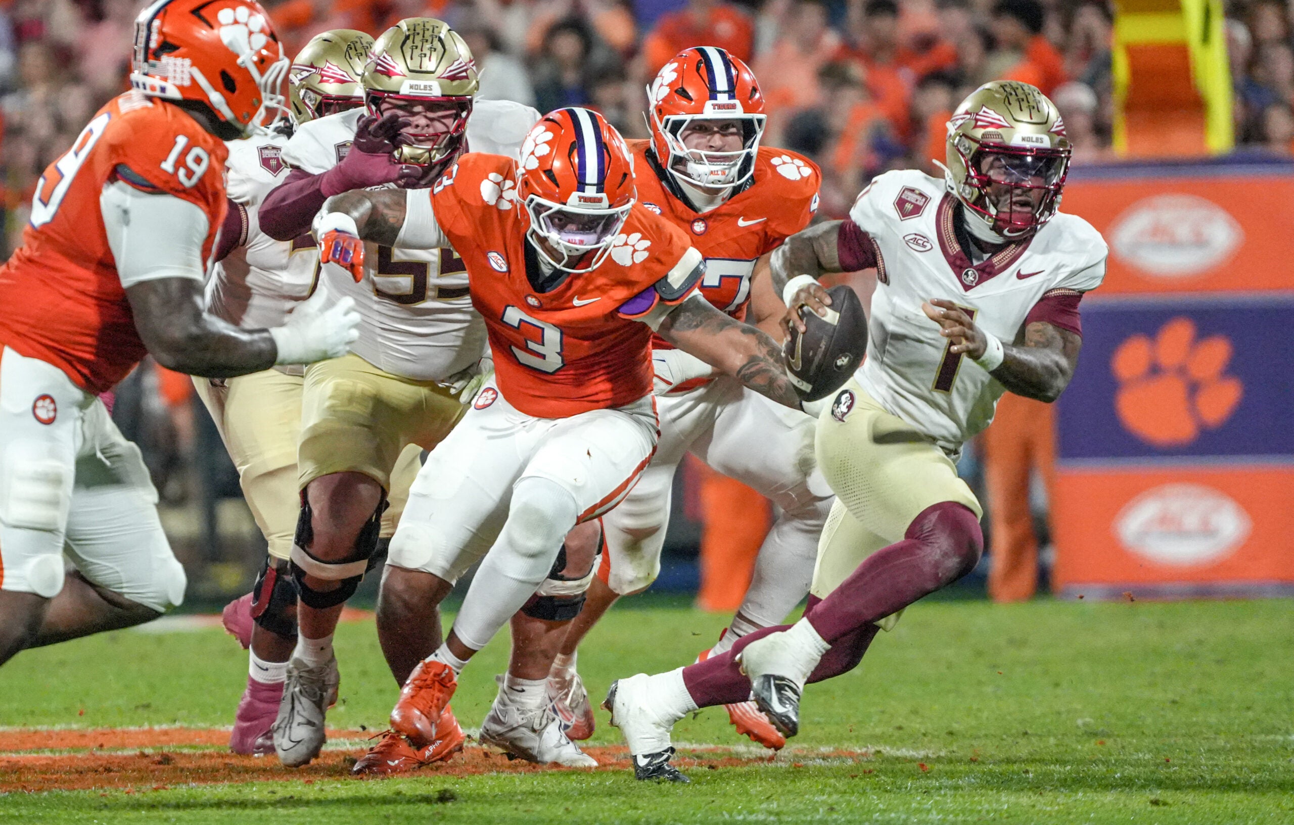 Nov 8, 2025; Clemson, South Carolina, USA; Florida State Seminoles quarterback Tommy Castellanos (1) runs near Clemson Tigers defensive end T.J. Parker (3) during the second quarter at Memorial Stadium.