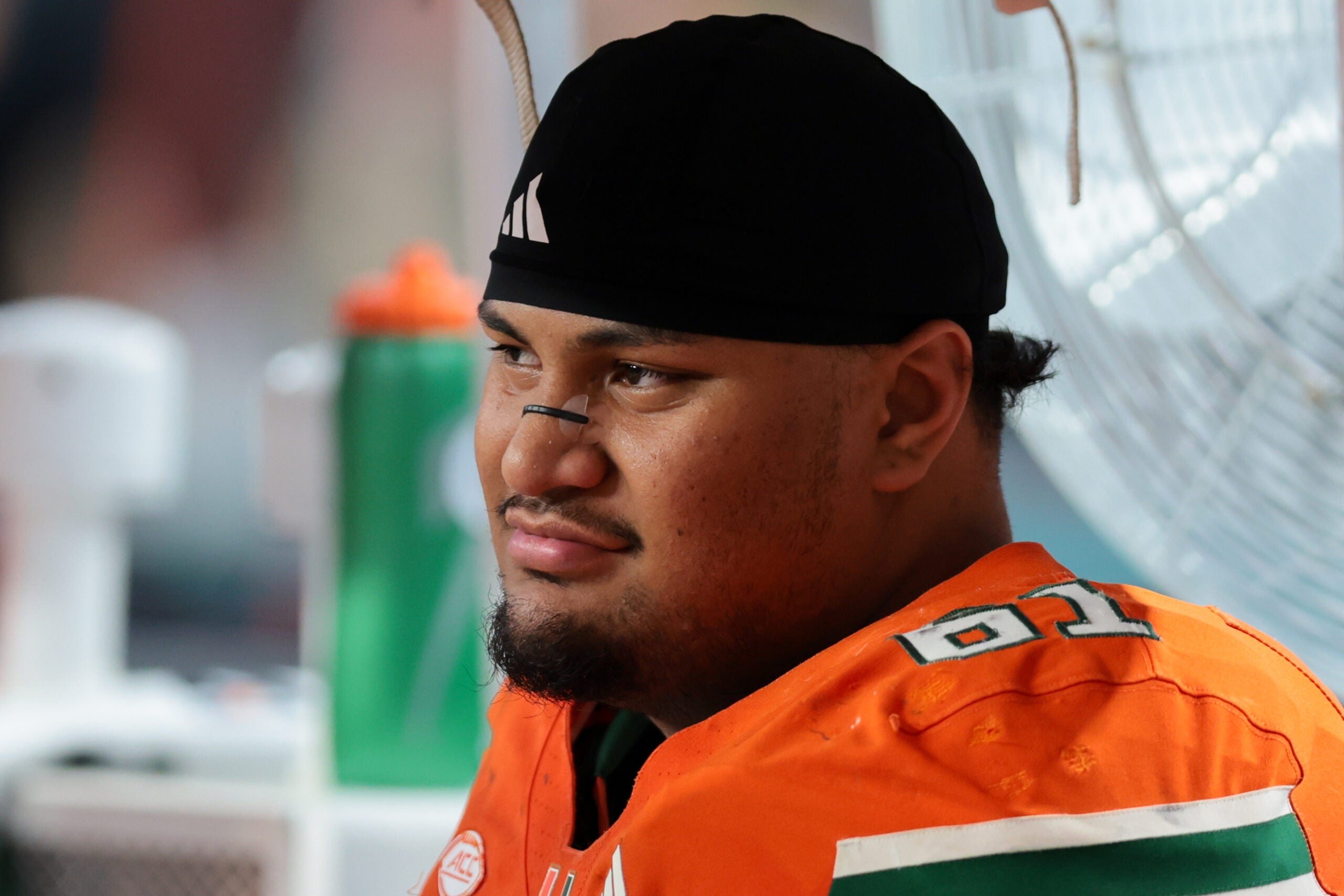 Nov 15, 2025; Miami Gardens, Florida, USA; Miami Hurricanes offensive lineman Francis Mauigoa (61) watches from the bench against NC State Wolfpack during the third quarter at Hard Rock Stadium.