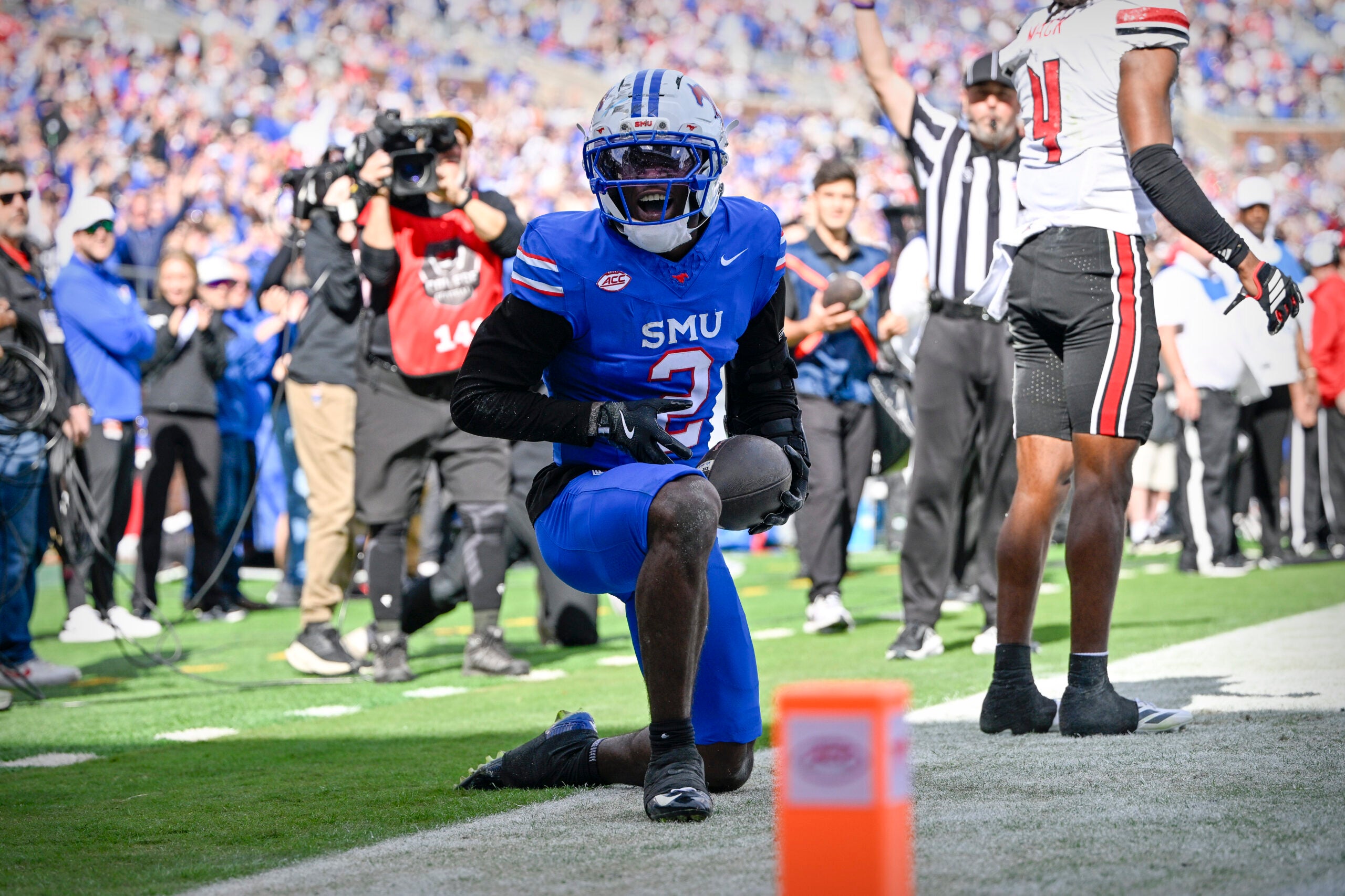 Nov 22, 2025; Dallas, Texas, USA; SMU Mustangs wide receiver Jordan Hudson (2) celebrates after he scores a touchdown against the Louisville Cardinals during the first half at Gerald J. Ford Stadium.