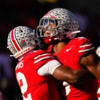 Ohio State Buckeyes defensive back Caleb Downs (2) celebrates with linebacker Sonny Styles (0) after sacking Rutgers Scarlet Knights quarterback Athan Kaliakmanis (16) in the second half of the NCAA football game at Ohio Stadium on Saturday, Nov. 22, 2025 in Columbus, Ohio.
