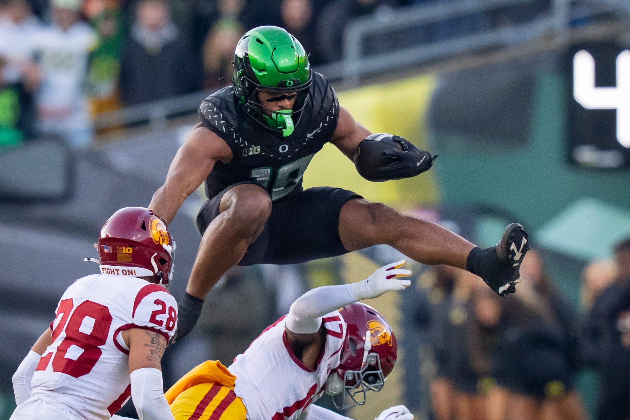 Oregon tight end Kenyon Sadiq hurdles over USC cornerback DeCarlos Nicholson as the Oregon Ducks host the USC Trojans on Nov. 22, 2025, at Autzen Stadium in Eugene, Oregon.