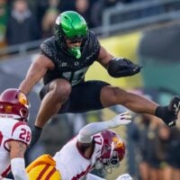 Oregon tight end Kenyon Sadiq hurdles over USC cornerback DeCarlos Nicholson as the Oregon Ducks host the USC Trojans on Nov. 22, 2025, at Autzen Stadium in Eugene, Oregon.