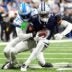 Detroit Lions cornerback Amik Robertson (21) tackles Dallas Cowboys wide receiver George Pickens (3) during the first half at Ford Field in Detroit on Thursday, Dec. 4, 2025.