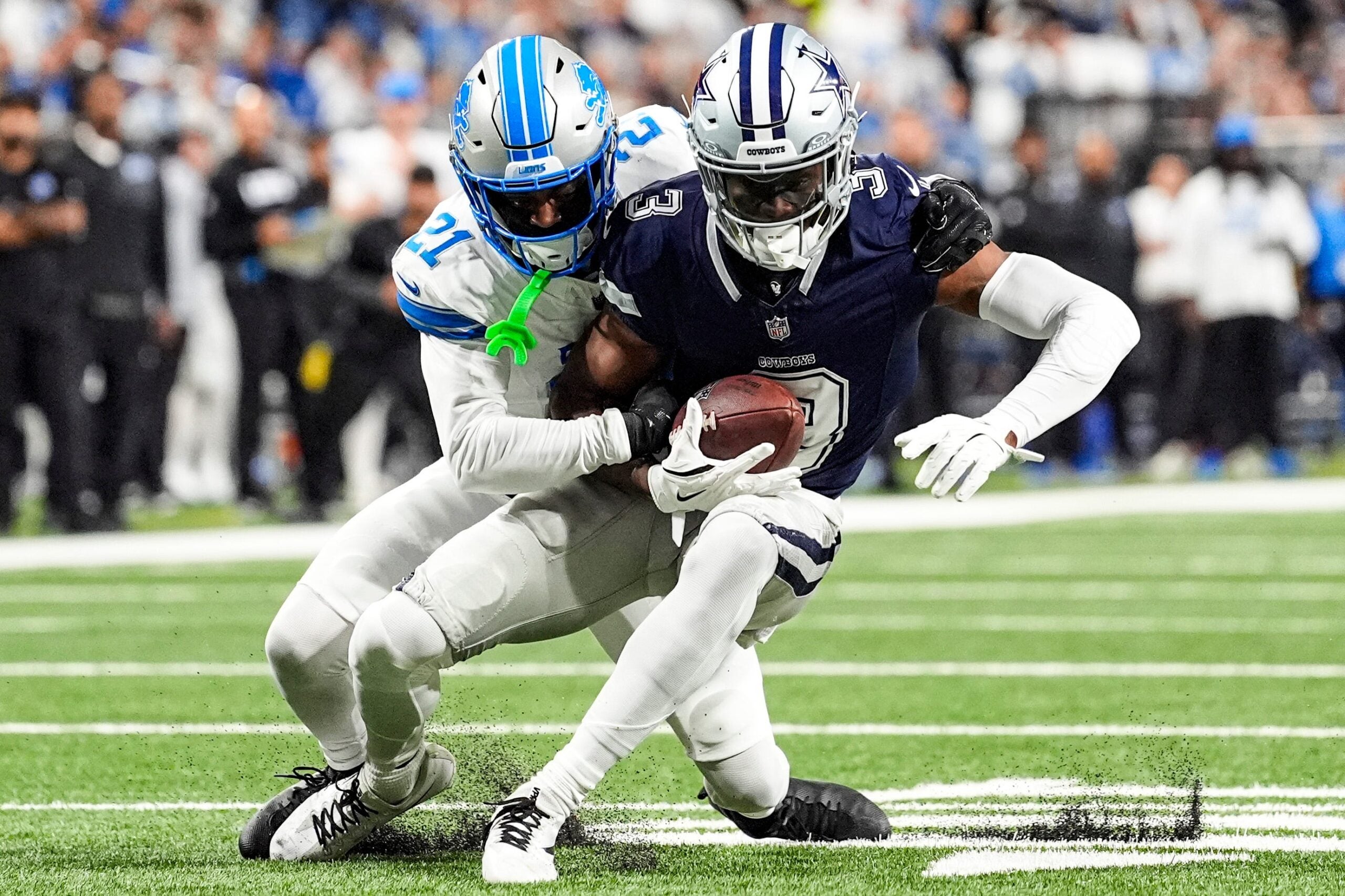 Detroit Lions cornerback Amik Robertson (21) tackles Dallas Cowboys wide receiver George Pickens (3) during the first half at Ford Field in Detroit on Thursday, Dec. 4, 2025.