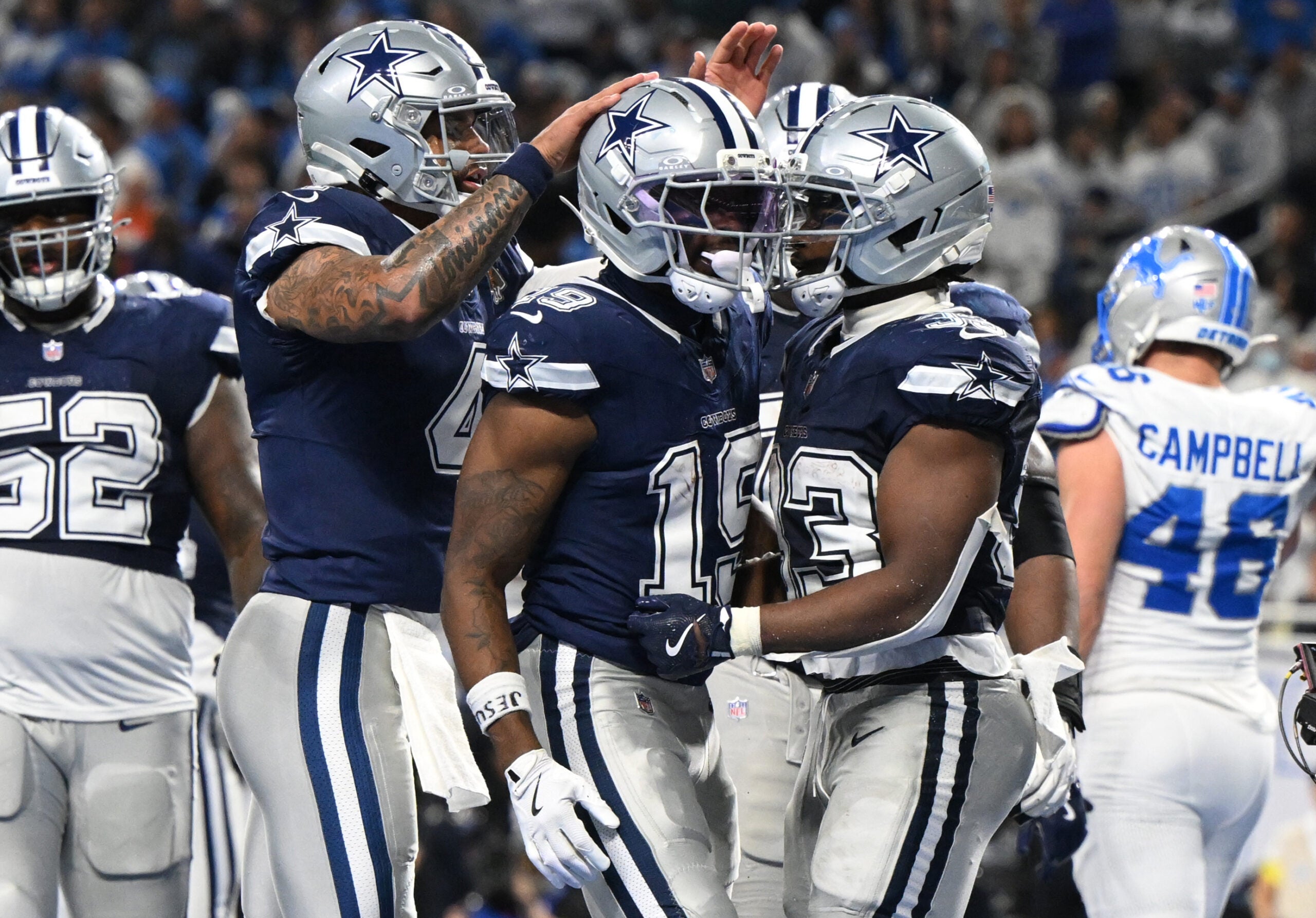 Dec 4, 2025; Detroit, Michigan, USA; Dallas Cowboys running back Javonte Williams (33) celebrates with quarterback Dak Prescott (4) and wide receiver Ryan Flournoy (19) after scoring a touchdown during the second half against the Detroit Lions at Ford Field.