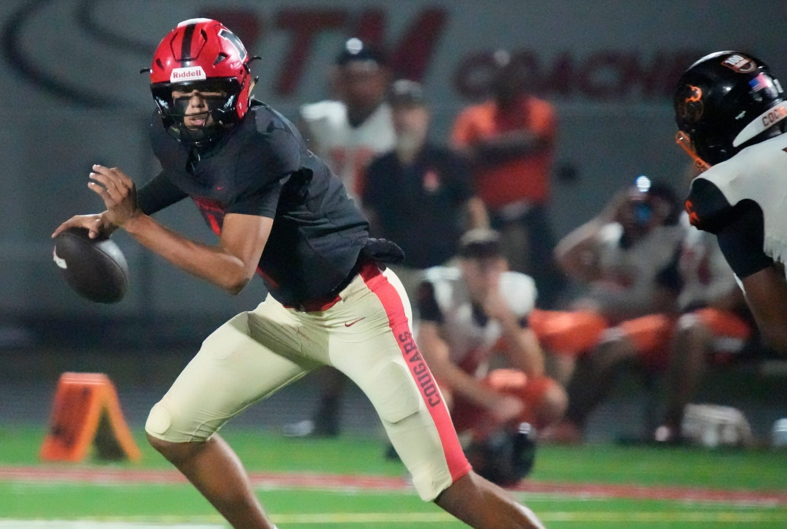 Mooney quarterback Davin Davidson (#4) scrambles as he looks for an open receiver. Cardinal Mooney Catholic High School hosted Cocoa High School for the Class 2A state semi-final football game Friday evening, Dec. 5, 2025. Mooney won the game 40-0.