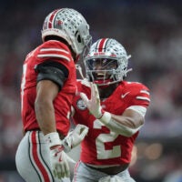 Dec 6, 2025; Indianapolis, IN, USA; Ohio State Buckeyes safety Caleb Downs (2) and cornerback Lorenzo Styles Jr. (3) react in the first half against the Indiana Hoosiers during the 2025 Big Ten championship game at Lucas Oil Stadium.