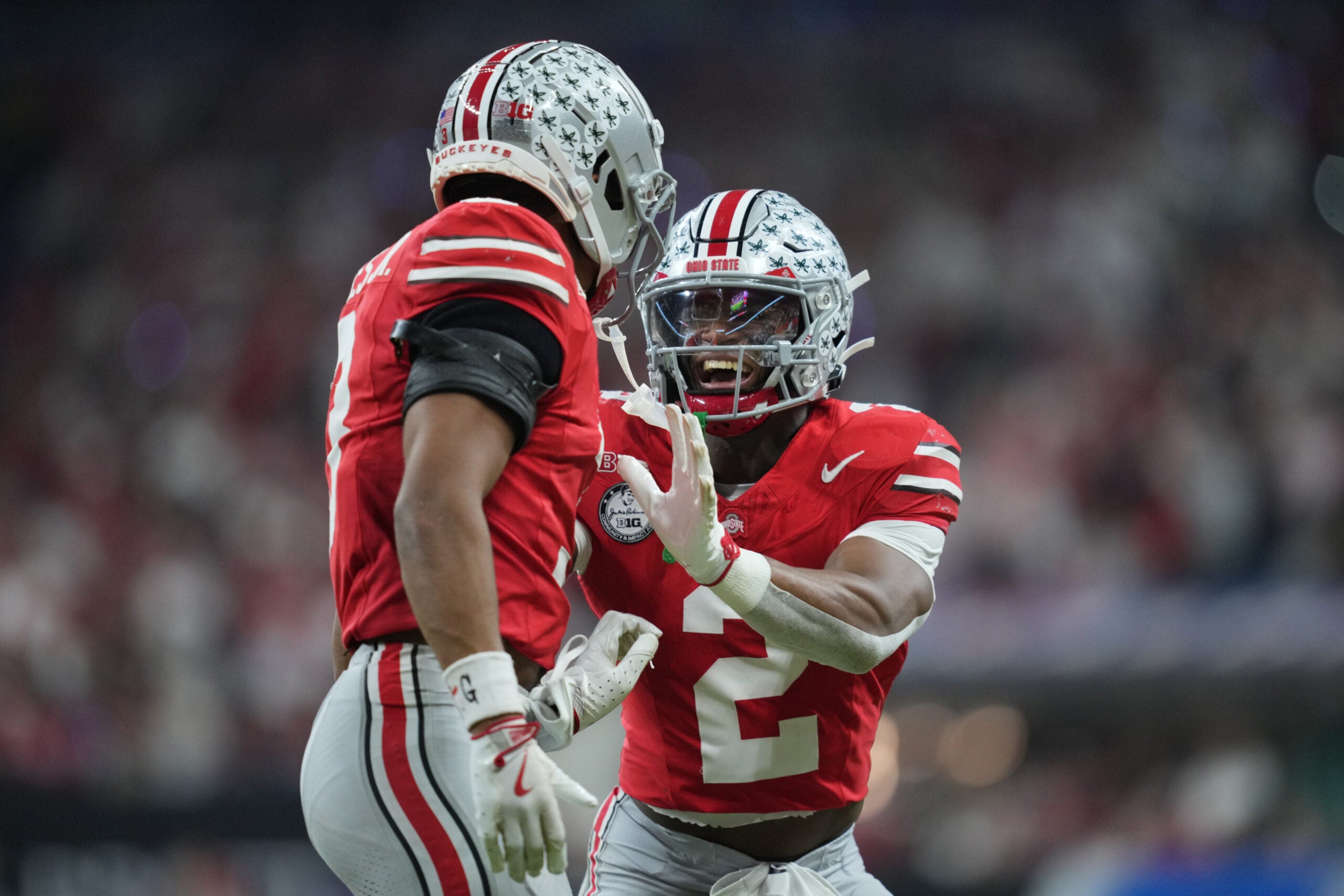 Dec 6, 2025; Indianapolis, IN, USA; Ohio State Buckeyes safety Caleb Downs (2) and cornerback Lorenzo Styles Jr. (3) react in the first half against the Indiana Hoosiers during the 2025 Big Ten championship game at Lucas Oil Stadium.