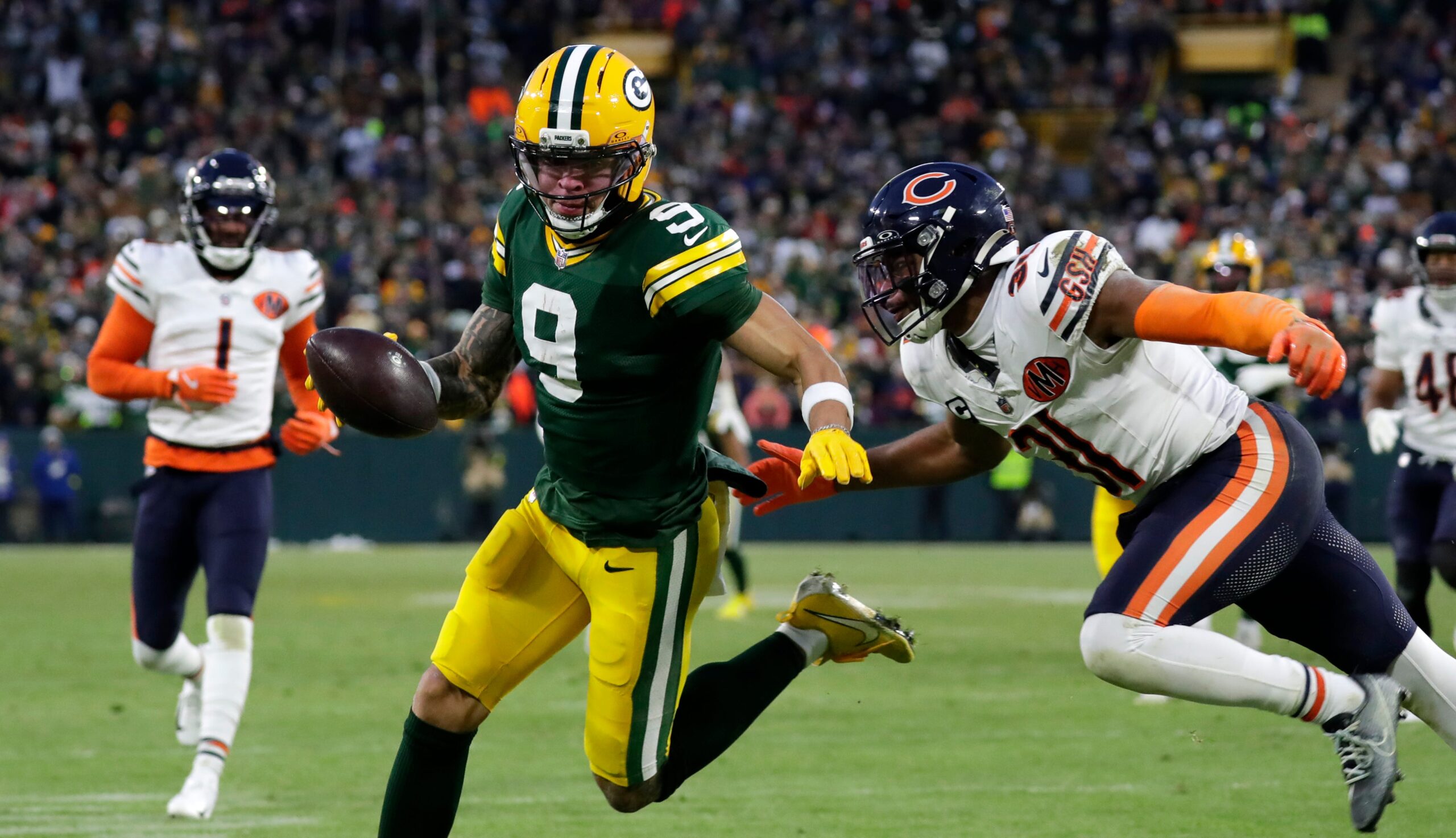 Green Bay Packers wide receiver Christian Watson (9) runs the ball in for a touchdown during a football game against the Chicago Bears on Dec. 7, 2025, at Lambeau Field.