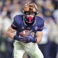 Dec 13, 2025; Baltimore, Maryland, USA; Navy Midshipmen slotback Eli Heidenreich (22) catches a pass for a touchdown against the Army Black Knights during the second half of the 126th Army-Navy game at M&T Bank Stadium