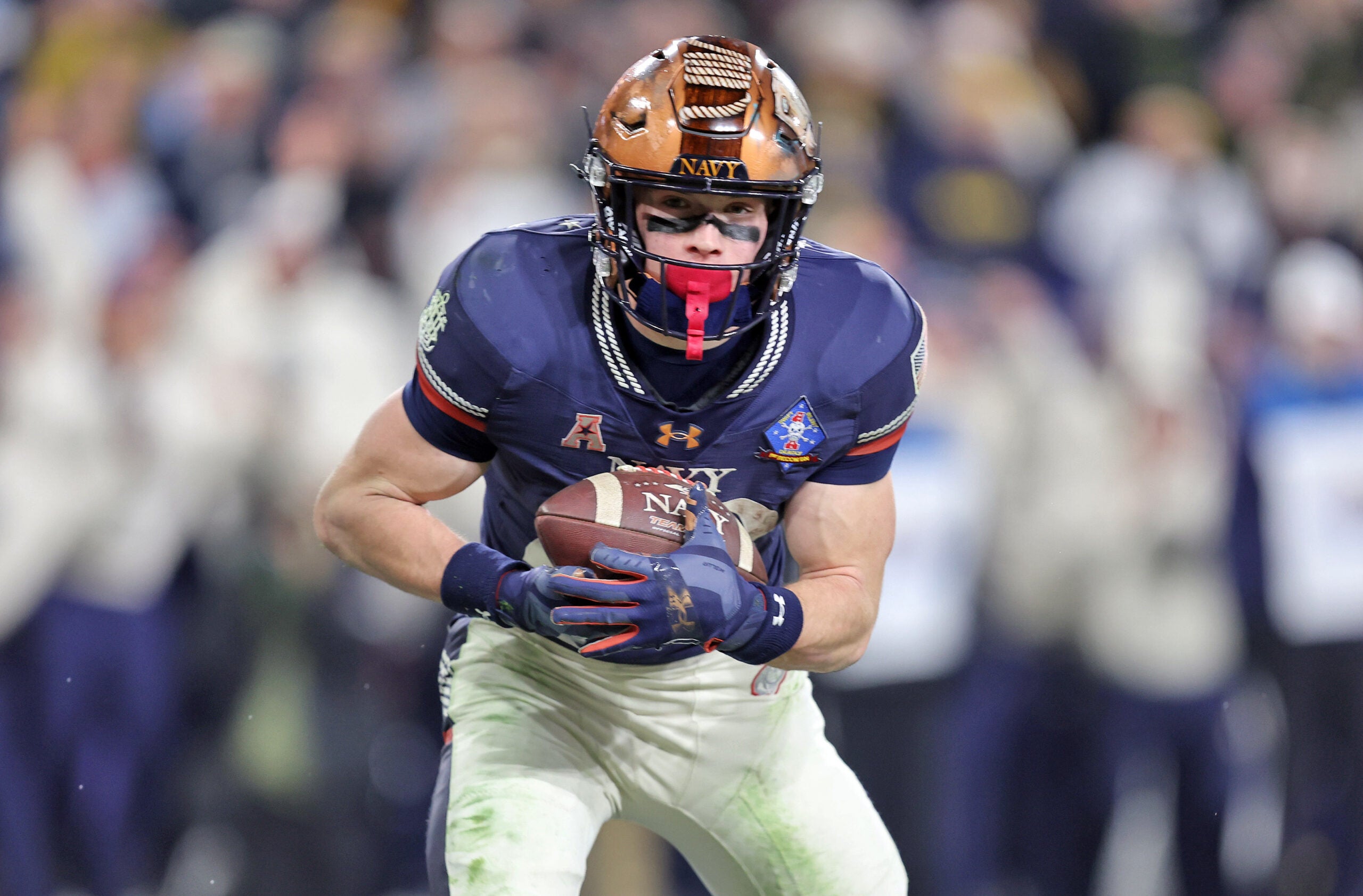 Dec 13, 2025; Baltimore, Maryland, USA; Navy Midshipmen slotback Eli Heidenreich (22) catches a pass for a touchdown against the Army Black Knights during the second half of the 126th Army-Navy game at M&T Bank Stadium