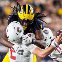 Michigan linebacker Jaishawn Barham (1) tackles New Mexico quarterback Jack Layne (2) during the second half at Michigan Stadium in Ann Arbor on Saturday, August 30, 2025.