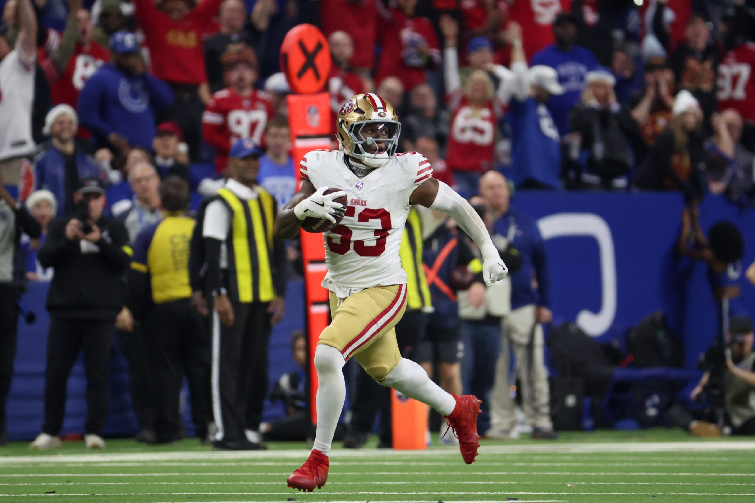 Dec 22, 2025; Indianapolis, Indiana, USA; San Francisco 49ers linebacker Dee Winters (53) carries the ball after an interception for a touchdown against the Indianapolis Colts in the fourth quarter of the game at Lucas Oil Stadium.