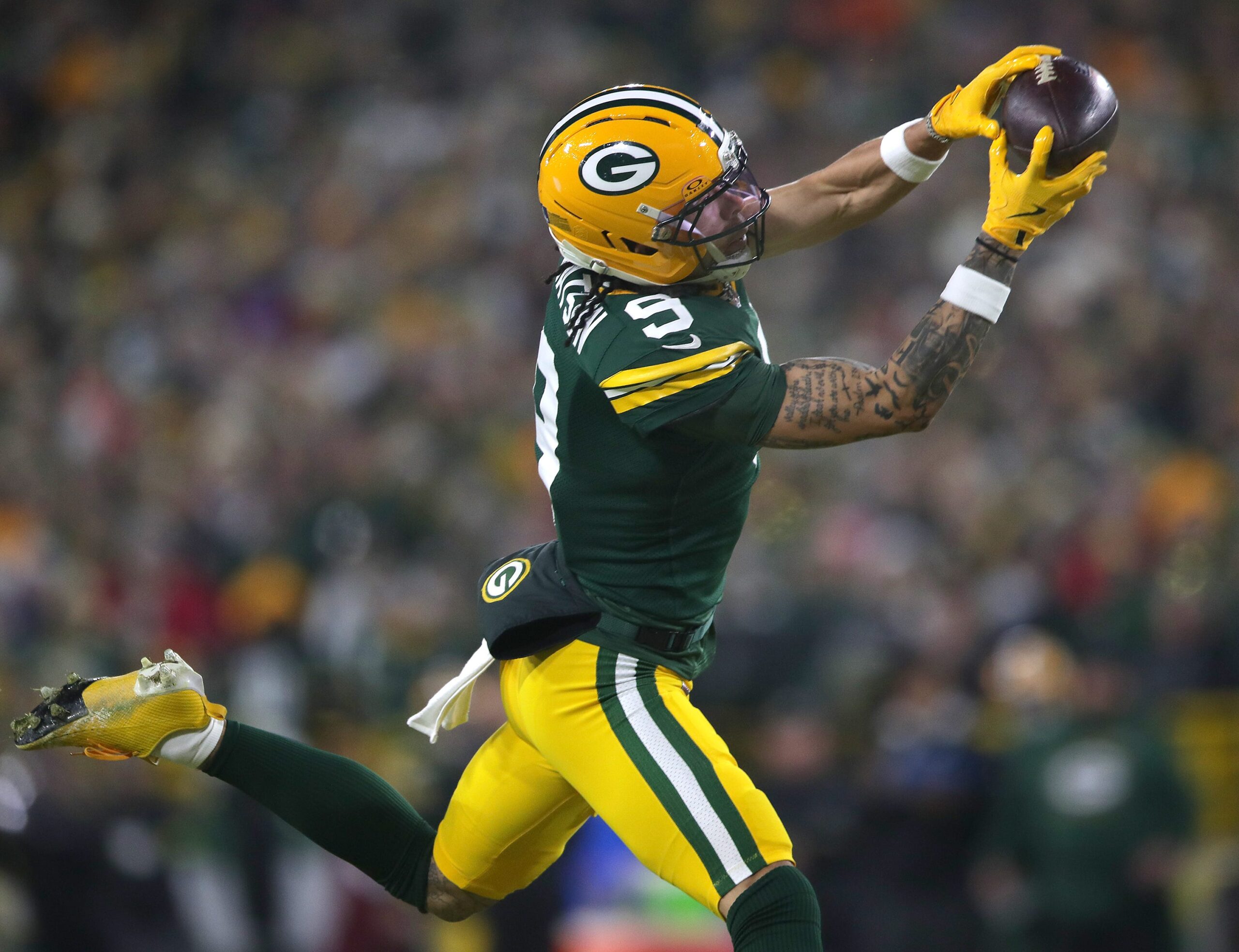 Green Bay Packers wide receiver Christian Watson (9) catches a touchdown pass against the Baltimore Ravens on Saturday, December 27, 2025, at Lambeau Field in Green Bay, Wis.