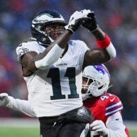 Dec 28, 2025; Orchard Park, New York, USA; Philadelphia Eagles wide receiver A.J. Brown (11) prepares to catch a pass against Buffalo Bills cornerback Christian Benford (47) during the first quarter at Highmark Stadium.