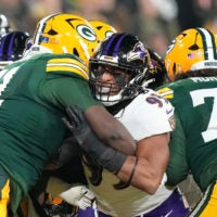 Dec 27, 2025; Green Bay, Wisconsin, USA; Baltimore Ravens linebacker Tavius Robinson (95) against Green Bay Packers offensive tackle Anthony Belton (71) and Green Bay Packers guard Jordan Morgan (77) during the second quarter at Lambeau Field.