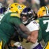 Dec 27, 2025; Green Bay, Wisconsin, USA; Baltimore Ravens linebacker Tavius Robinson (95) against Green Bay Packers offensive tackle Anthony Belton (71) and Green Bay Packers guard Jordan Morgan (77) during the second quarter at Lambeau Field.