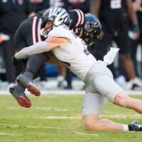 Oregon defensive back Dillon Thieneman, right, brings down Texas Tech quarterback Behren Morton as the Oregon Ducks take on the Texas Tech Red Raiders in the Orange Bowl on Jan. 1, 2026, at Hard Rock Stadium in Miami, Florida.