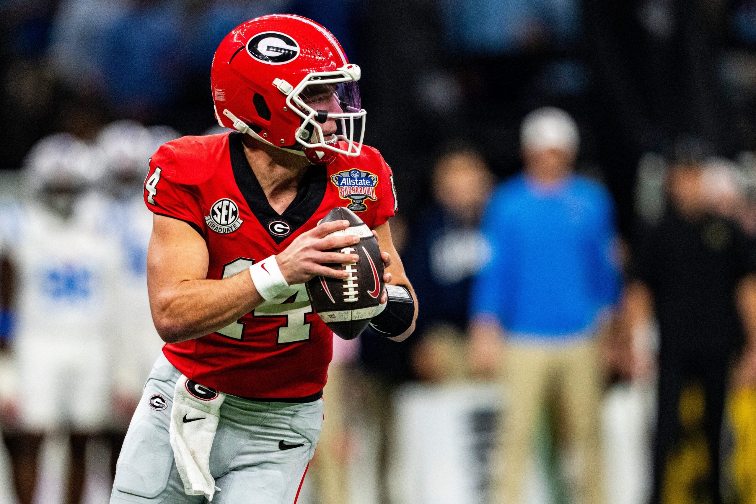 Georgia quarterback Gunner Stockton (14) rolls out of the pocket during the Sugar Bowl and College Football Playoff quarterfinals at Caesars Superdome in New Orleans, La., on Thursday, Jan. 1, 2026. Ole Miss defeated Georgia 39-34.