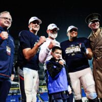 Navy’s Blake Horvath (11), middle left, head coach Brian Newberry, Landon Robinson, and Navy Superintendent Lieutenant General Michael Borgschulte pose for a photo as they become the new AutoZone Liberty Bowl champions after defeating the Cincinnati Bearcats on Jan. 2, 2026 at Simmons Bank Liberty Stadium in Memphis, Tenn.