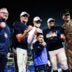 Navy’s Blake Horvath (11), middle left, head coach Brian Newberry, Landon Robinson, and Navy Superintendent Lieutenant General Michael Borgschulte pose for a photo as they become the new AutoZone Liberty Bowl champions after defeating the Cincinnati Bearcats on Jan. 2, 2026 at Simmons Bank Liberty Stadium in Memphis, Tenn.
