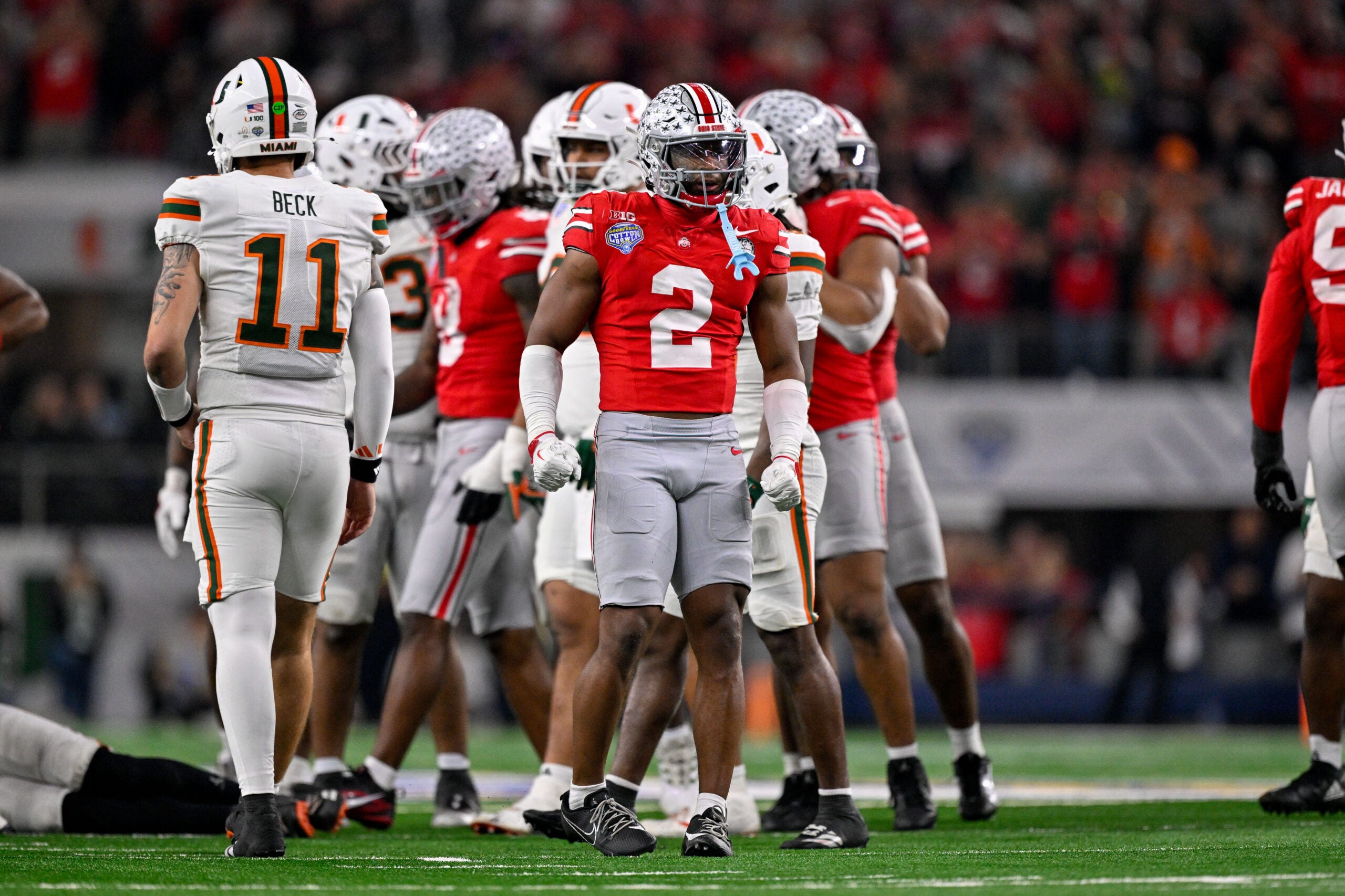 Dec 31, 2025; Arlington, TX, USA; Ohio State Buckeyes safety Caleb Downs (2) celebrates a defensive stop during the 2025 Cotton Bowl and quarterfinal game of the College Football Playoff at AT&T Stadium.