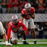 Arlington, TX, USA; Ohio State Buckeyes defensive end Kenyatta Jackson Jr. (97) and linebacker Sonny Styles (0) get into position during the 2025 Cotton Bowl and quarterfinal game of the College Football Playoff at AT&T Stadium.