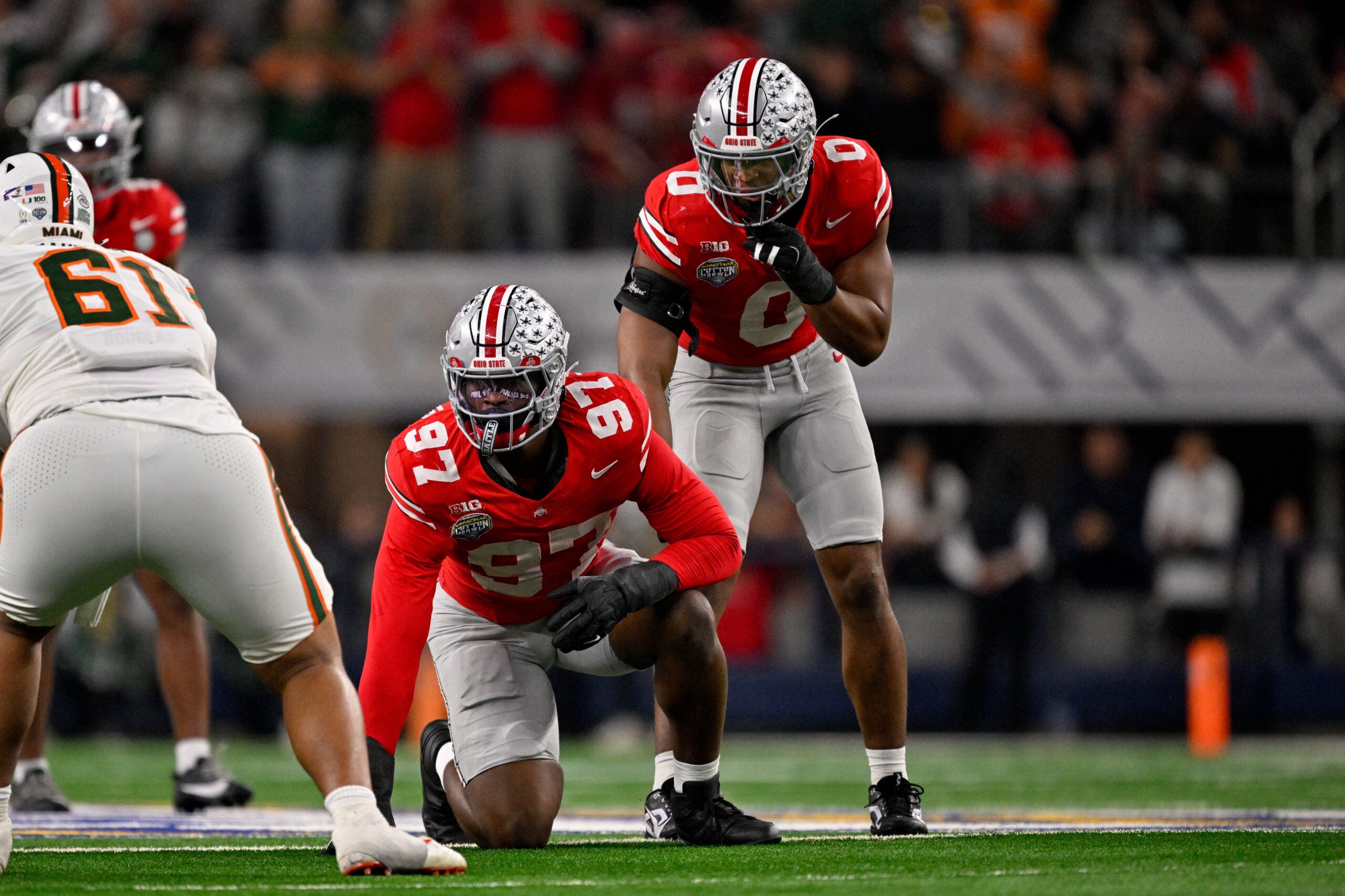 Arlington, TX, USA; Ohio State Buckeyes defensive end Kenyatta Jackson Jr. (97) and linebacker Sonny Styles (0) get into position during the 2025 Cotton Bowl and quarterfinal game of the College Football Playoff at AT&T Stadium.