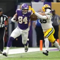 Minnesota Vikings tight end Josh Oliver (84) stiff arms Green Bay Packers linebacker Jamon Johnson (48) on a first down reception during their football game Sunday, January 4, 2026, at U.S. Bank Stadium in Minneapolis, Minnesota.