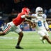 Jan 1, 2026; New Orleans, LA, USA; Georgia Bulldogs defensive back Kj Bolden (4) tackles Mississippi Rebels quarterback Trinidad Chambliss (6) in the second quarter during the 2026 Sugar Bowl and quarterfinal game of the College Football Playoff at Caesars Superdome.