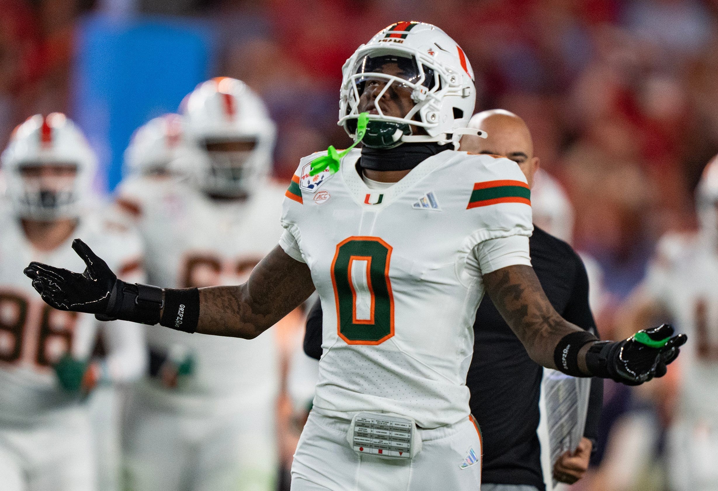 Miami Hurricanes defensive back Keionte Scott (0) runs onto the field at the start of the CFP Fiesta Bowl against Ole Miss at the State Farm Stadium, in Glendale, Ariz., on Thursday, Jan. 8, 2026.