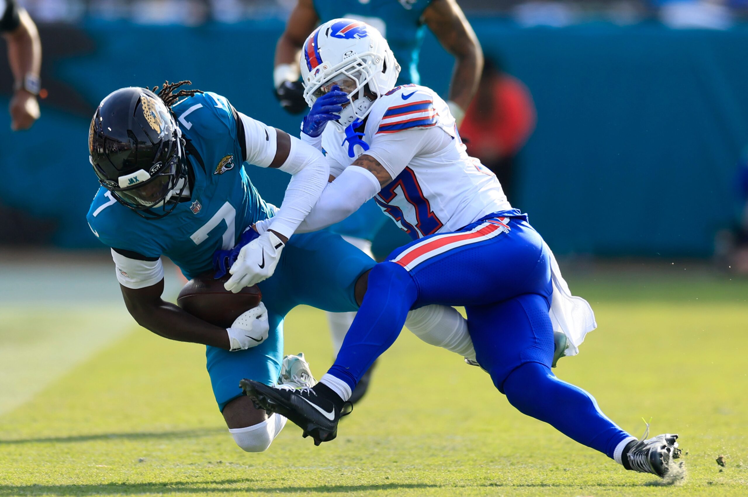 Jacksonville Jaguars wide receiver Brian Thomas Jr. (7) is tackled by Buffalo Bills cornerback Jordan Hancock (37) during the third quarter of an NFL football AFC Wild Card playoff matchup, Sunday, Jan. 11, 2026, in Jacksonville, Fla. The Bills defeated the Jaguars 27-24.