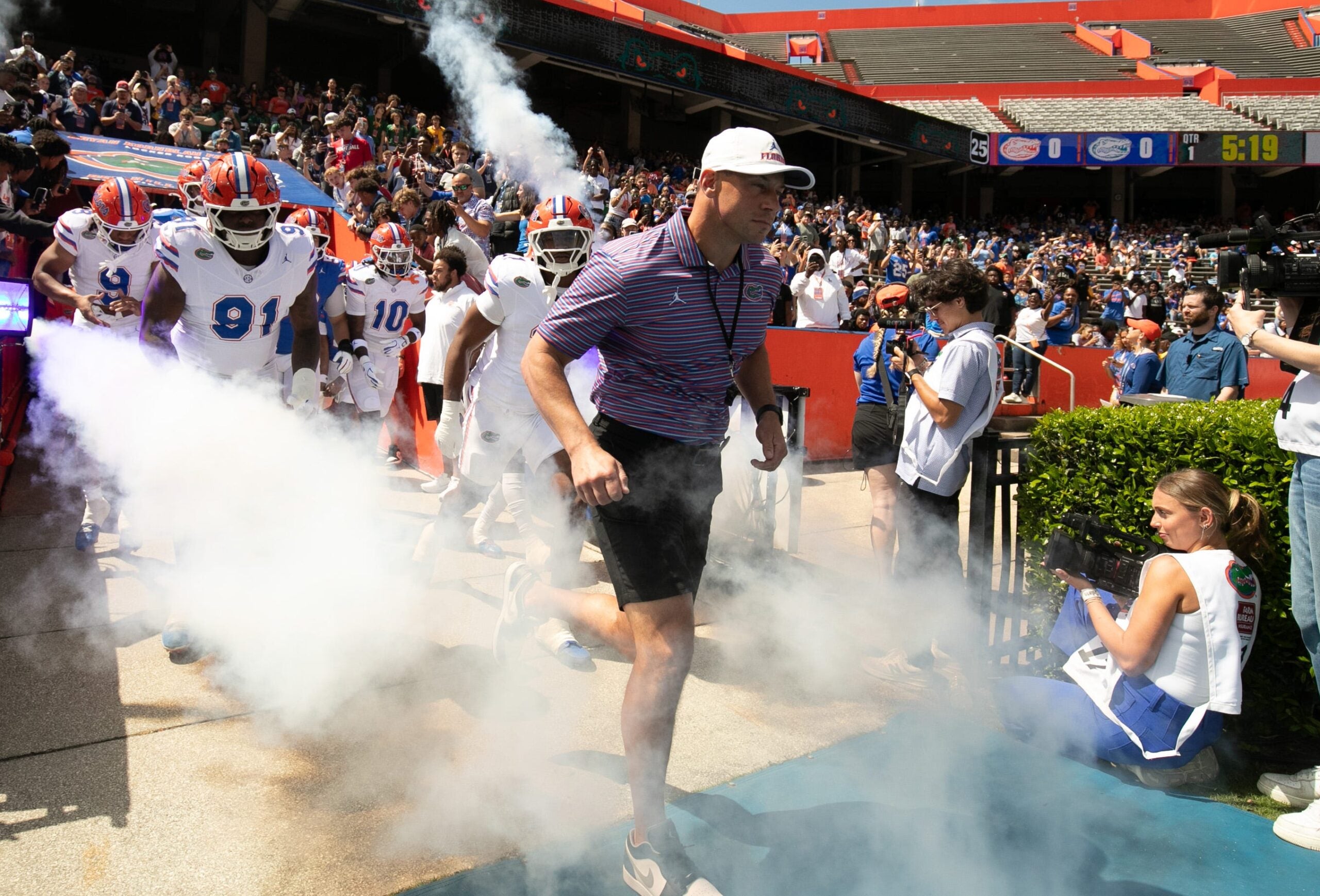 Florida head coach Jon Sumrall and the team blasts out onto the field before the Orange and Blue game at Steve Spurrier Field at Ben Hill Griffin Stadium in Gainesville, FL on Saturday, April 11, 2026.