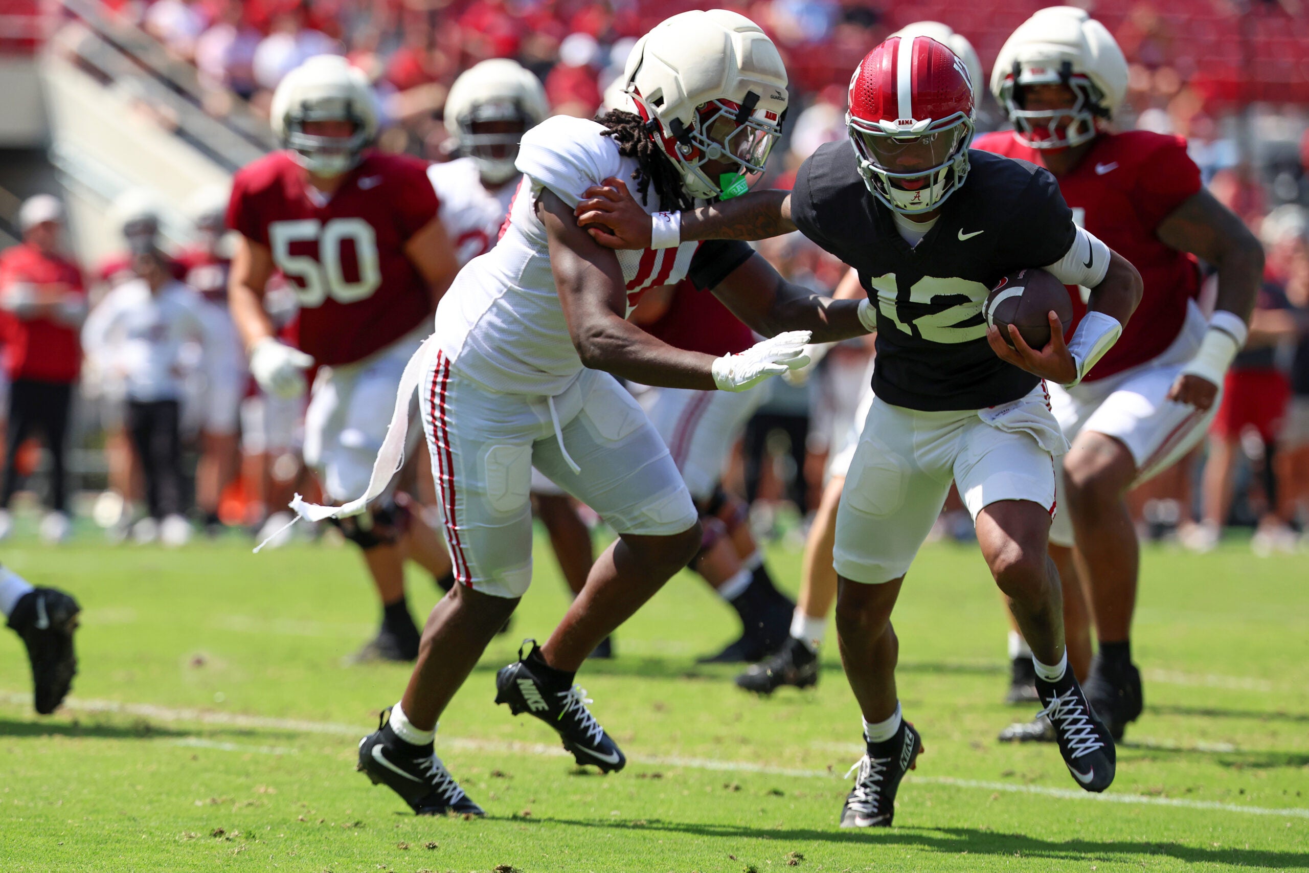 Apr 11, 2026; Tuscaloosa, AL, USA; Alabama Crimson Tide quarterback Austin Mack (10) pursues quarterback Keelon Russell (12) during the Alabama A-Day spring football scrimmage game at Saban Field at Bryant-Denny Stadium.
