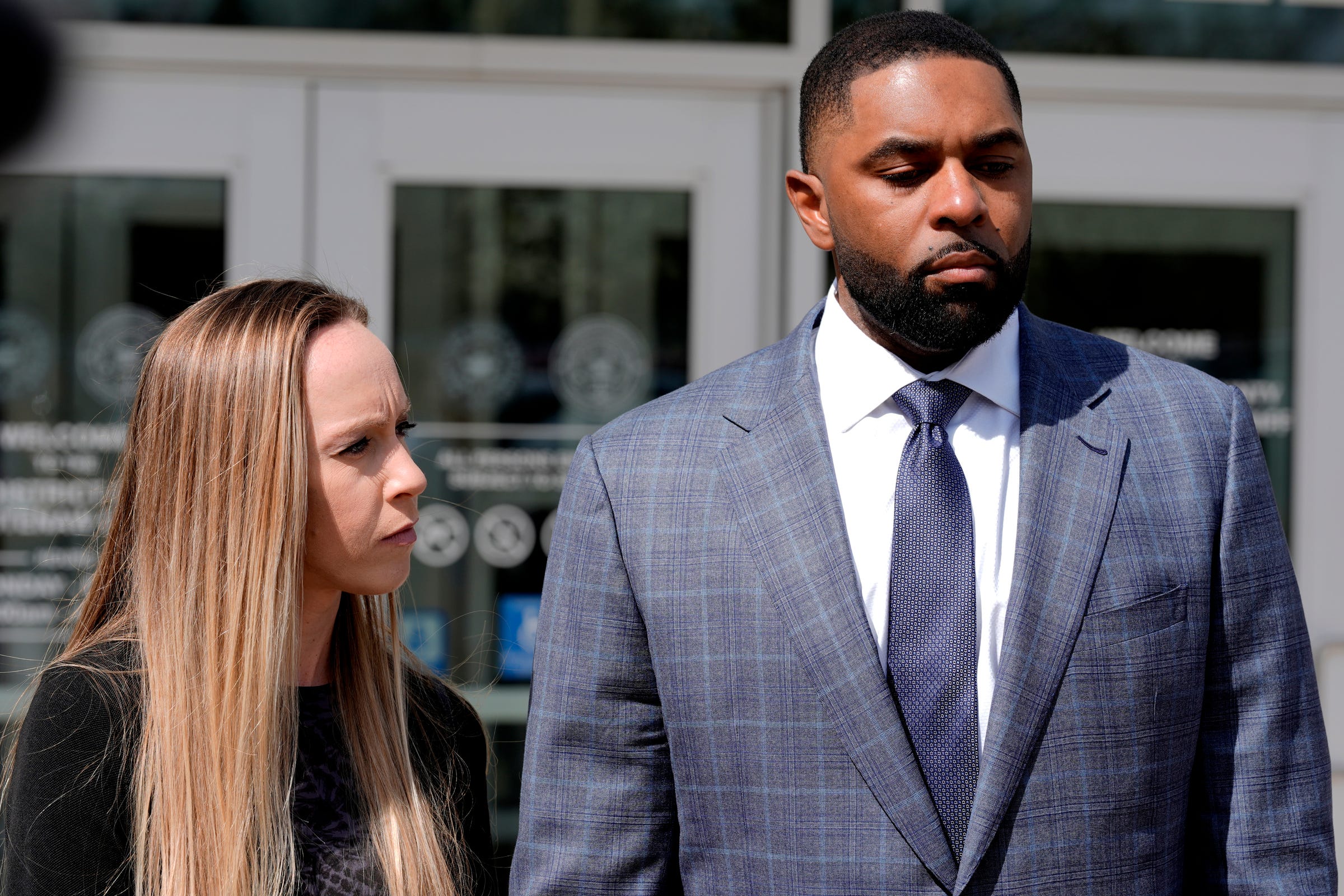 Former University of Michigan football coach Sherrone Moore and his wife Kelli Moore listen to his lawyer, Ellen Michaels, talk to the media after his suspended sentence ruling in the courtroom of Judge J. Cedric Simpson at 14A-1 District Court in Ann Arbor on Tuesday, April, 14, 2026.