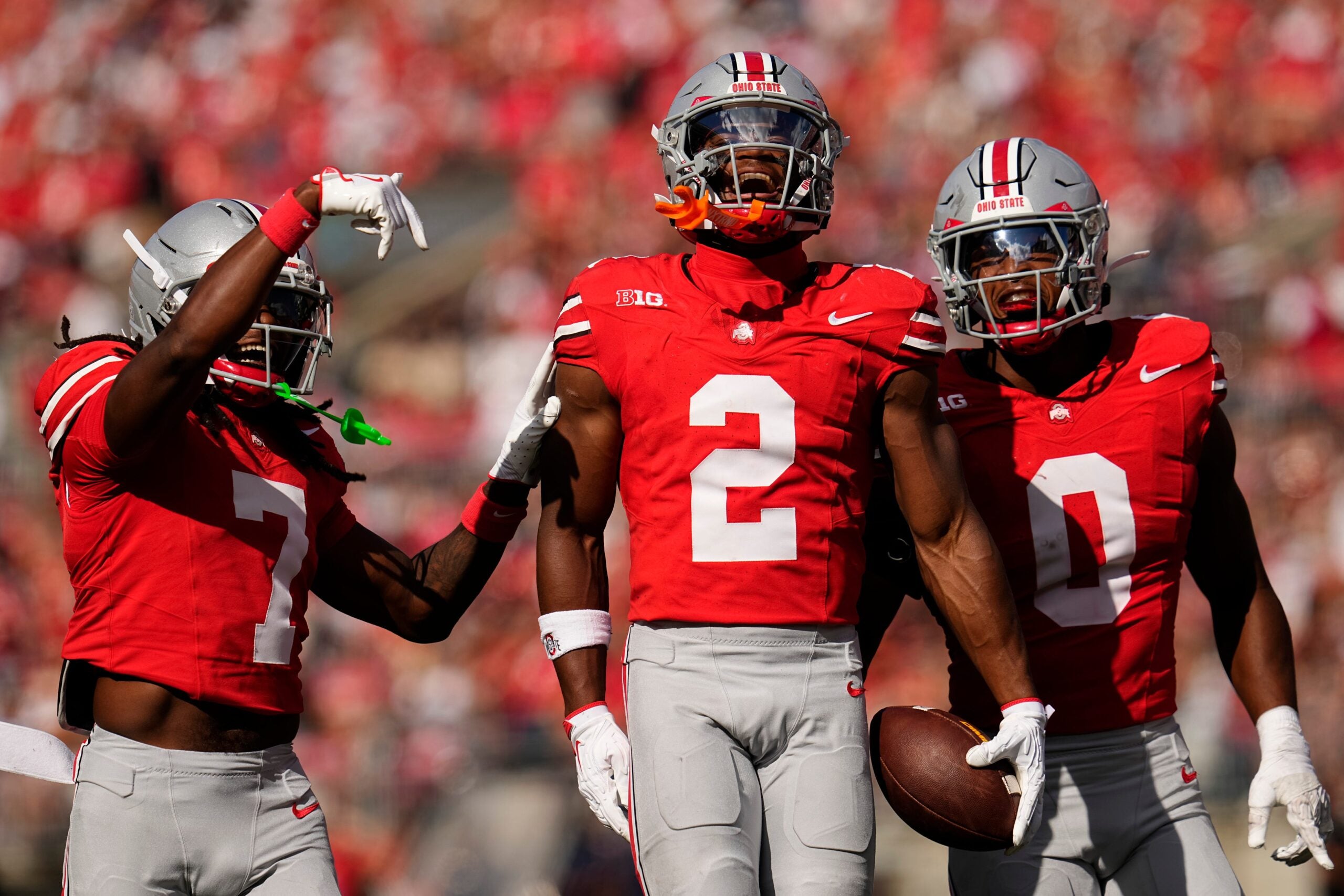 Ohio State Buckeyes safety Caleb Downs (2) celebrates an interception with cornerback Jermaine Mathews Jr. (7) abnd linebacker Sonny Styles (0) during the first half of the NCAA football game against the Grambling State Tigers at Ohio Stadium on Sept. 6, 2025.