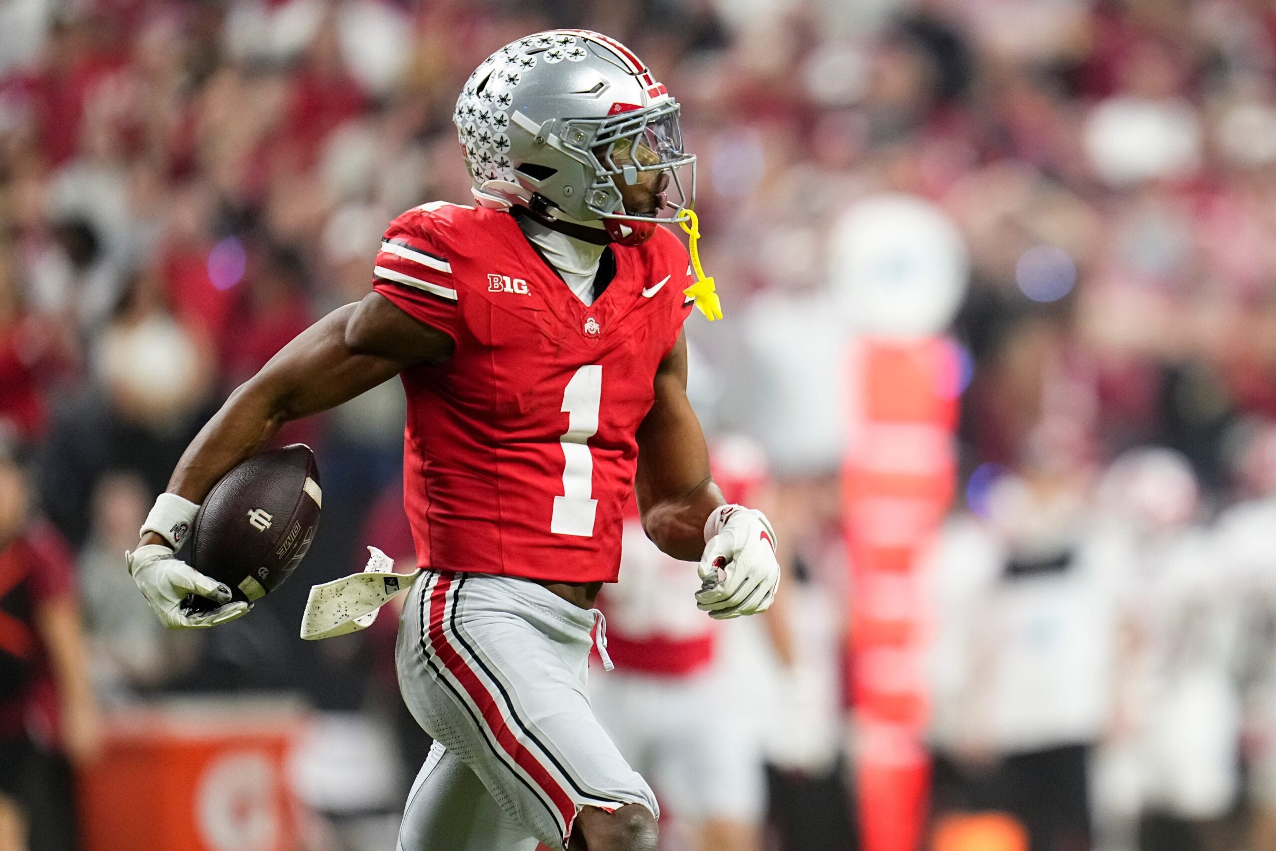 Ohio State Buckeyes cornerback Davison Igbinosun (1) celebrates an interception during the first half of the Big Ten Conference championship game against the Indiana Hoosiers at Lucas Oil Stadium in Indianapolis on Dec. 6, 2025.