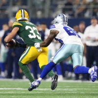 Jan 15, 2017; Arlington, TX, USA; Green Bay Packers strong safety Micah Hyde (33) runs the ball against Dallas Cowboys wide receiver Dez Bryant (88) after an interception during the third quarter in the NFC Divisional playoff game at AT&T Stadium.