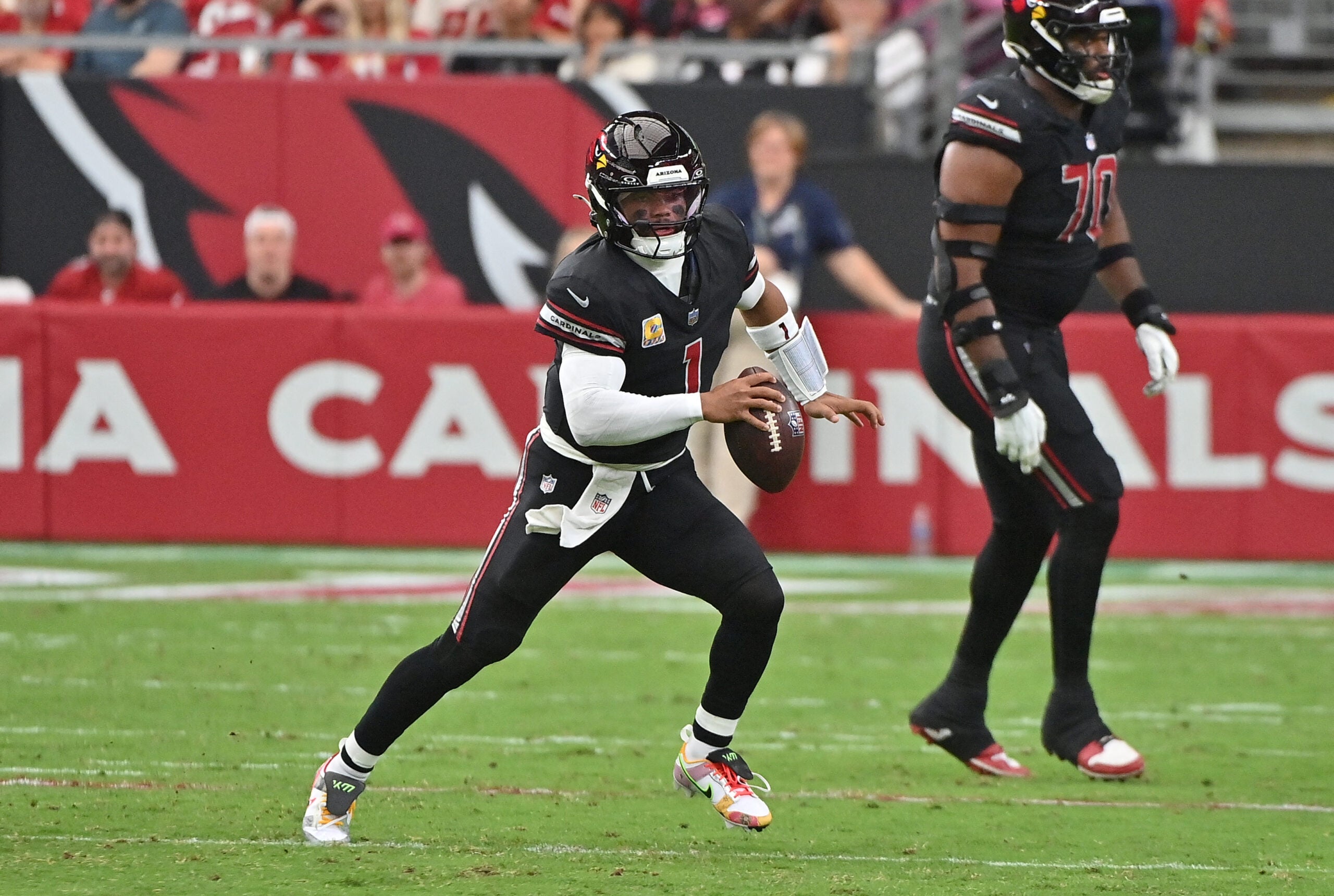 Oct 5, 2025; Glendale, Arizona, USA; Arizona Cardinals quarterback Kyler Murray (1) looks to throw against the Tennessee Titans during the second quarter at State Farm Stadium.