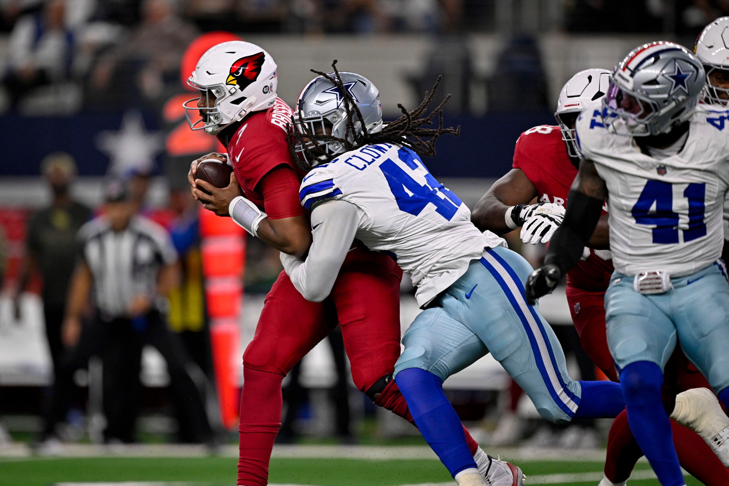 Nov 3, 2025; Arlington, Texas, USA; Dallas Cowboys defensive end Jadeveon Clowney (42) sacks Arizona Cardinals quarterback Jacoby Brissett (7) during the game between the Dallas Cowboys and the Arizona Cardinals at AT&T Stadium.